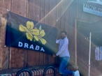 Quest Morris, a DRABA ambassador, hangs up the company’s flag at Knowledge Perk in Rock Hill Sept. 4 (photo: Abigail Helm).